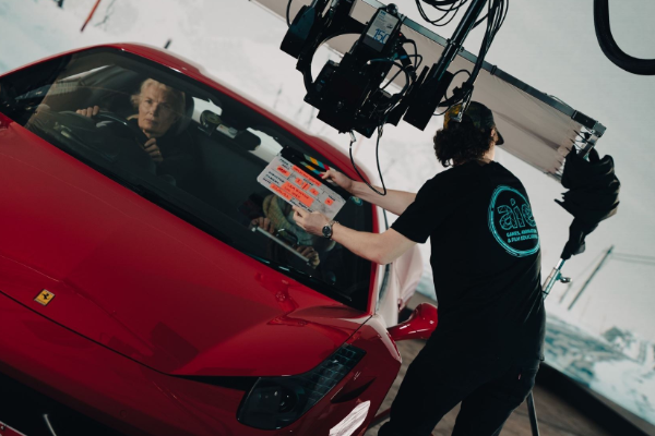 Virtual production studio using an LED wall behind a vehicle shoot